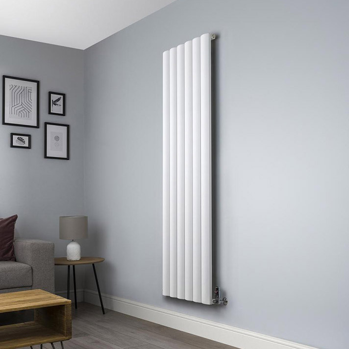 Vertical designer radiator in a contemporary living room with floor-to-ceiling windows